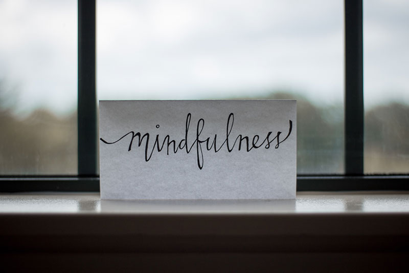 Sign that says mindfulness in cursive